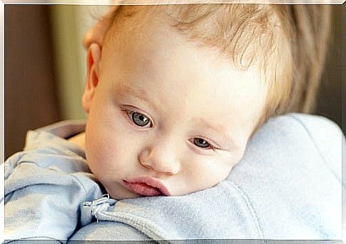 A feverish baby in his mother's arms