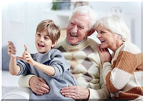 A selfie of a little boy with his grandparents.