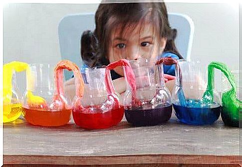 A girl doing an experiment with water.