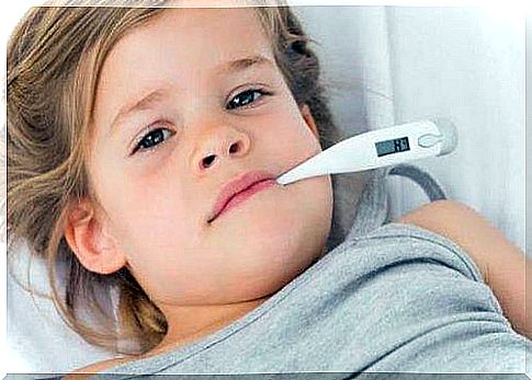 A girl with a thermometer in her mouth