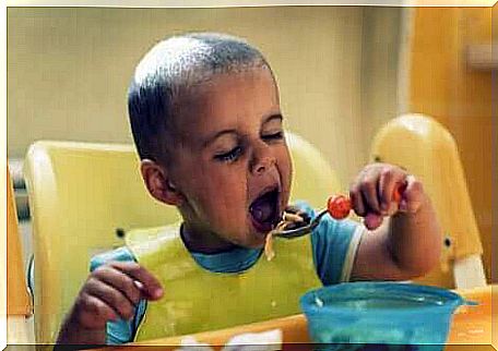 A child eating with a spoon.