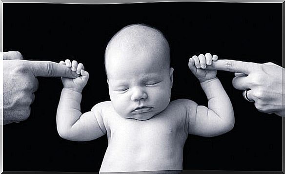 Baby holding mother and father's finger 