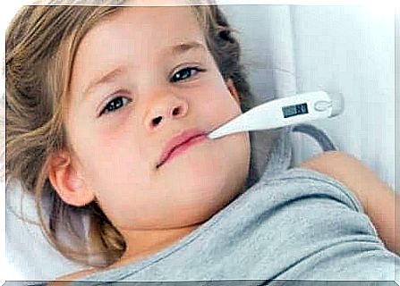 A young girl with a thermometer in her mouth. 