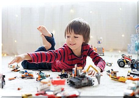 A child playing alone with his toys.