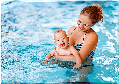 Baby in the water with mom