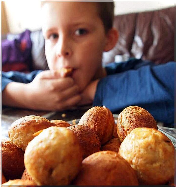 A little boy eats donuts 