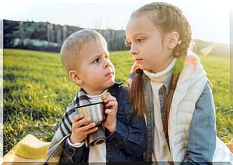 An angry brother and sister in a field. 