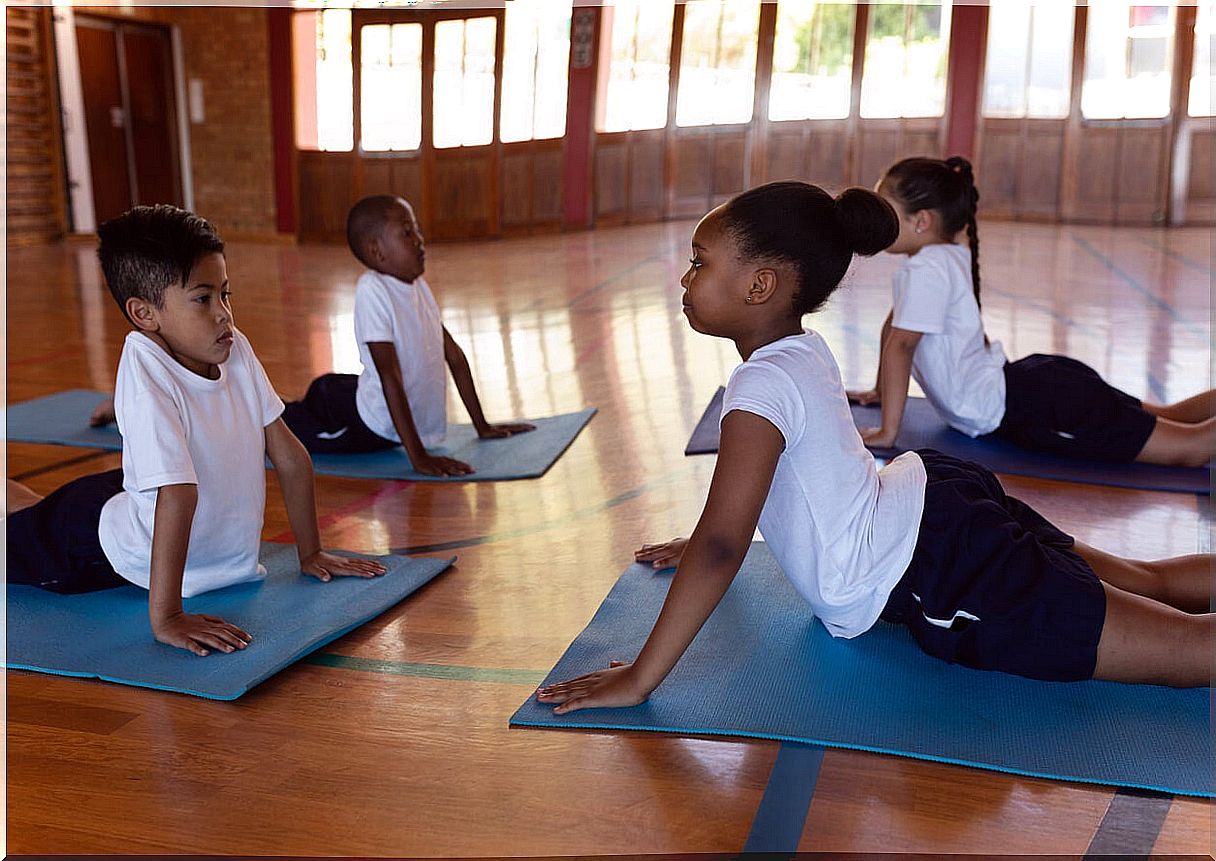 Children practicing head up dog pose.