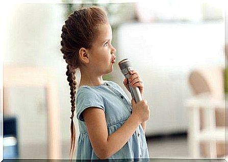 A girl sings into the microphone