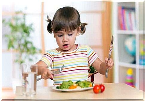 little girl eating vegetables