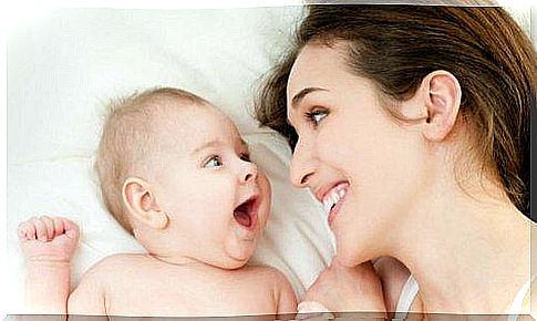 stimulate hearing A mother smiles at her baby