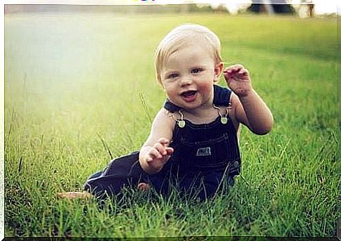 A laughing baby in a park 