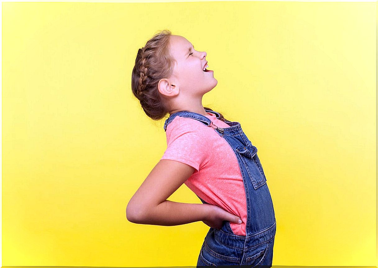 Young girl suffering from low back pain. 