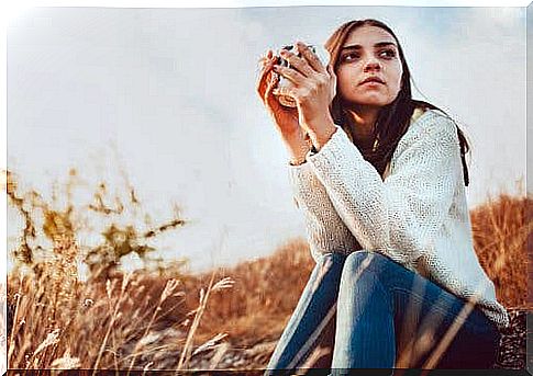 A young teenage girl drinking coffee. 