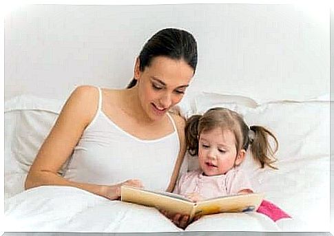 A mother reading a fairy tale to her daughter