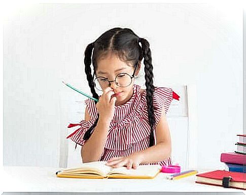 young girl studying attentively