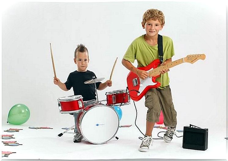 Children on guitar and drums, instruments that benefit children from learning