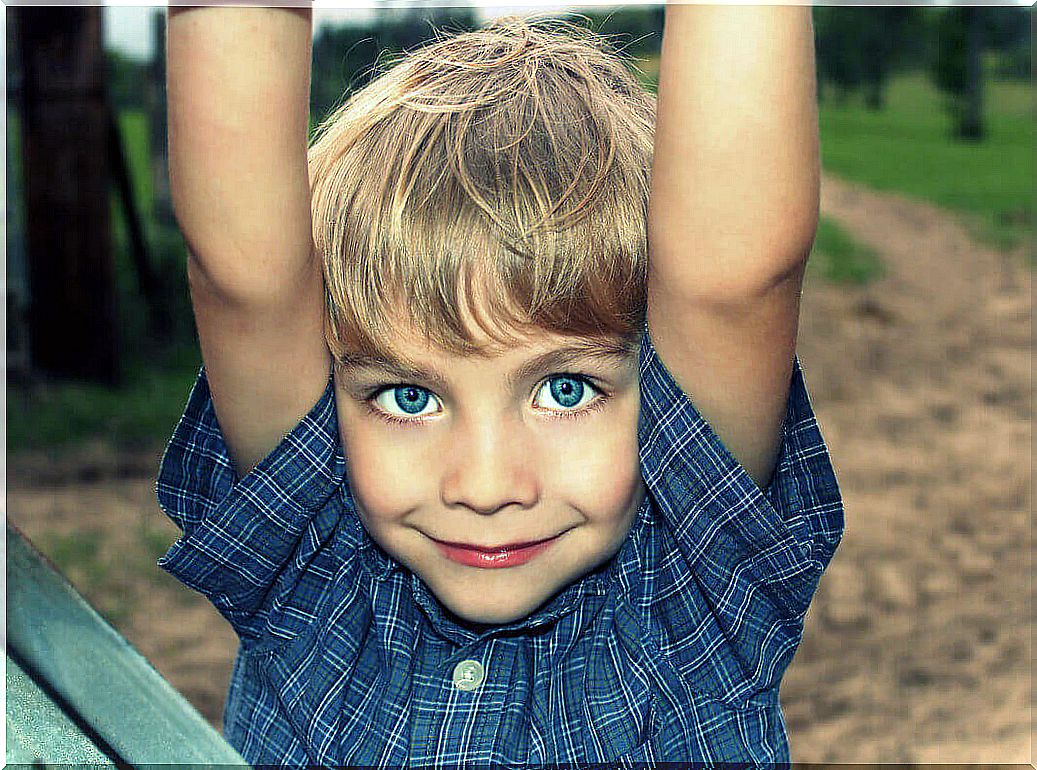 Blond boy with blue eyes in a creative play moment