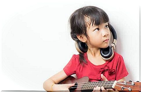 A girl playing the guitar.