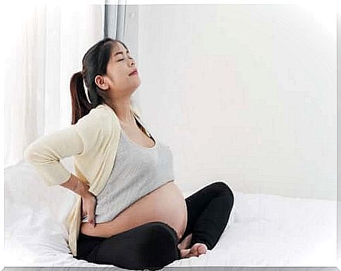 Pregnant woman stretching her back