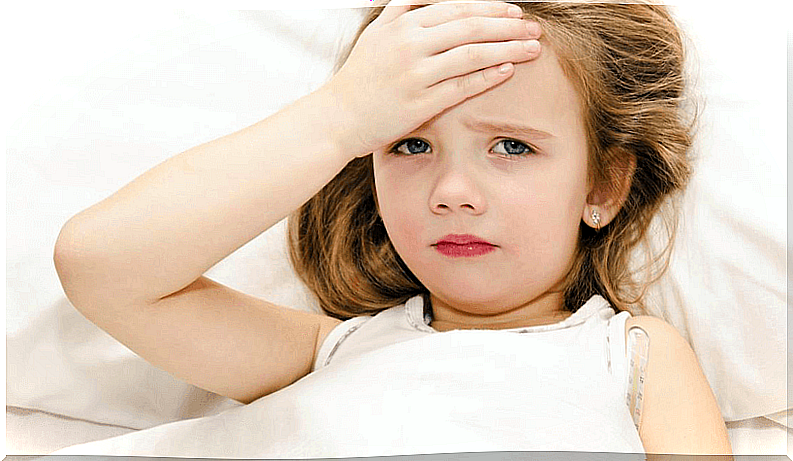 Little girl lying down suffering from headache