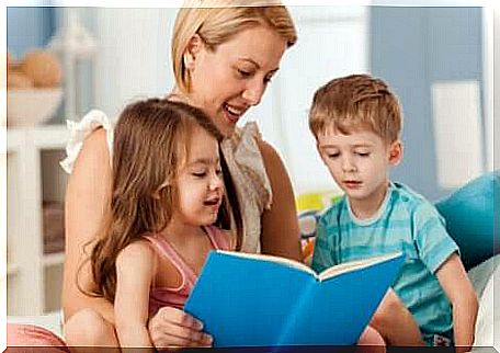 A mother reading a book to her children.